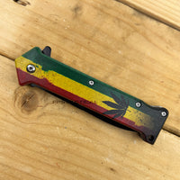 Pacific Solutions Marijuana Leaf Rasta Flag Spring Assisted Joker Stiletto Knife 3.75"
